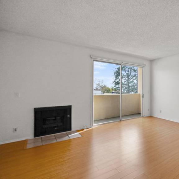 front entrance and living room area with fireplace and balcony