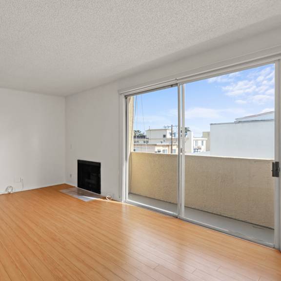 large living room with balcony and fireplace