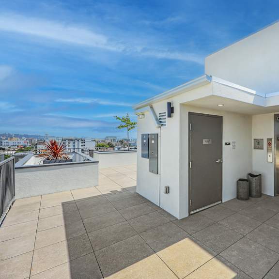a modern house with a balcony and a view of the city.