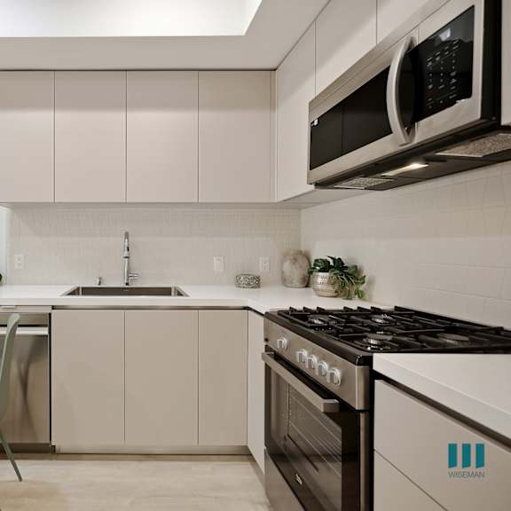 open-concept kitchen with stainless-steel appliances and ample cabinet storage