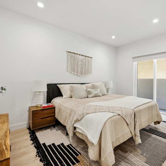 spacious bedroom with private patio, recessed lighting, and vinyl flooring