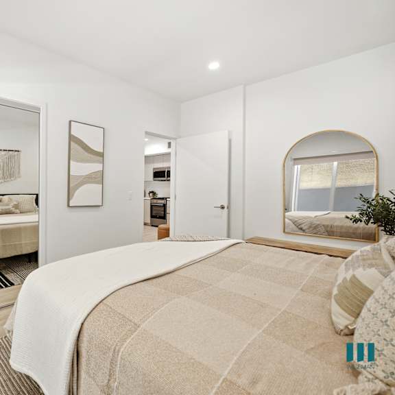 bedroom with a mirrored closet and built-in shelving