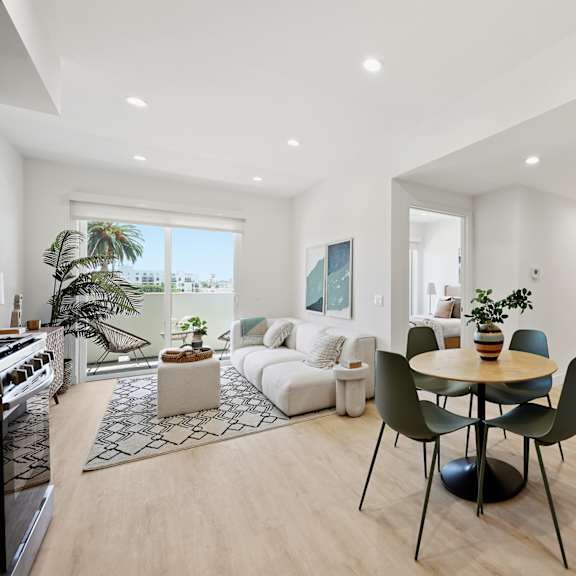 a modern living room with a dining table and chairs.