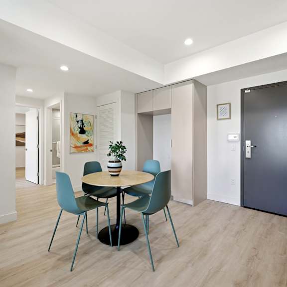 a dining room with a round table and chairs.