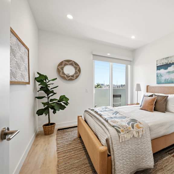 a bedroom with a large bed and a view of the city.