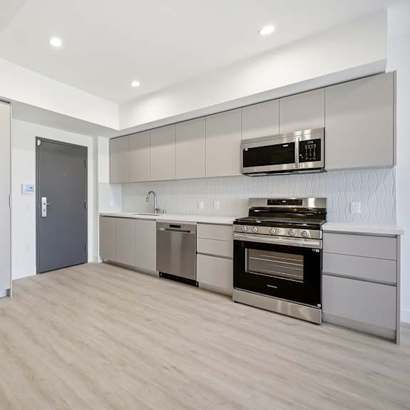 a modern kitchen with a stainless steel refrigerator and oven.