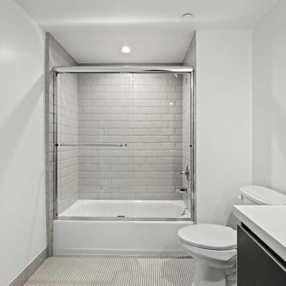 bathroom with shower bath with glass door