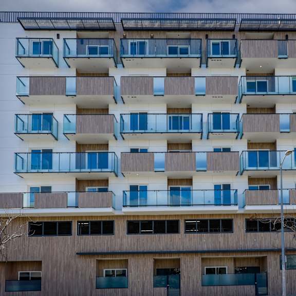 a modern building with balconies and a flat roof.