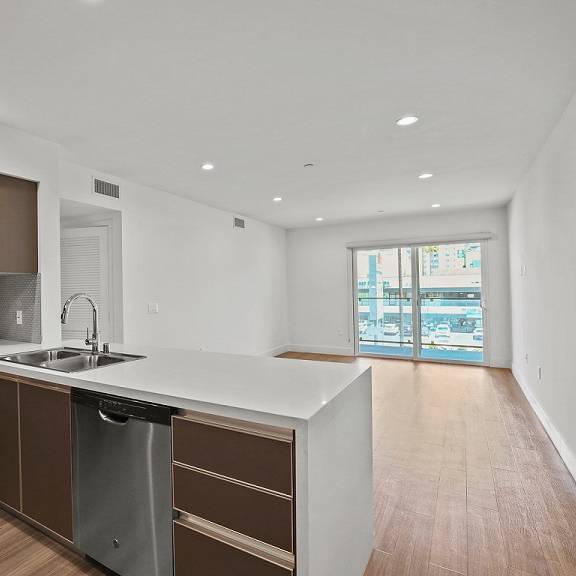 open-concept kitchen, dining, and living room areas