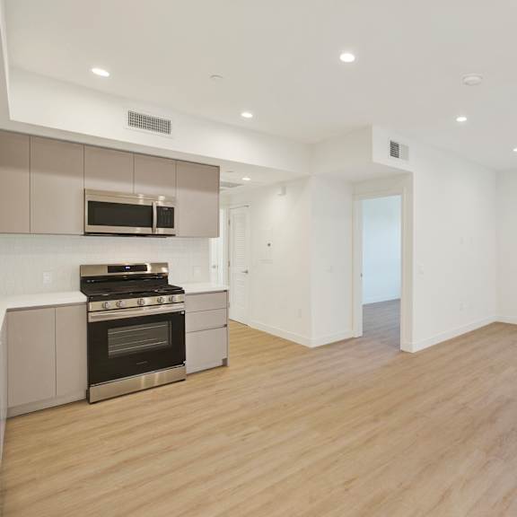 a modern kitchen with a stainless steel oven and microwave.