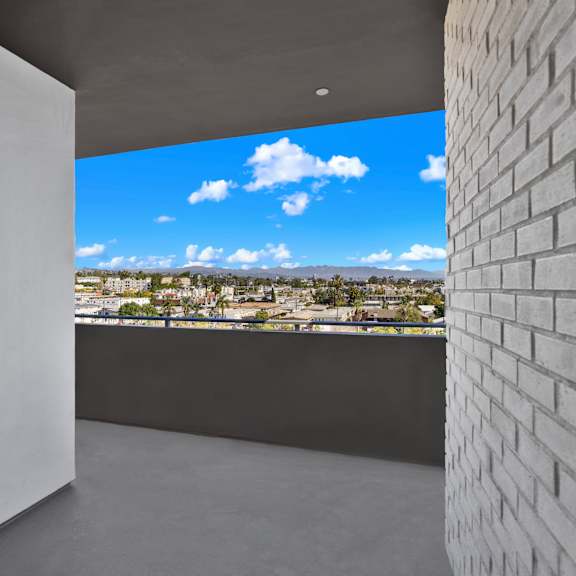a white wall with a view of the cityscape outside.