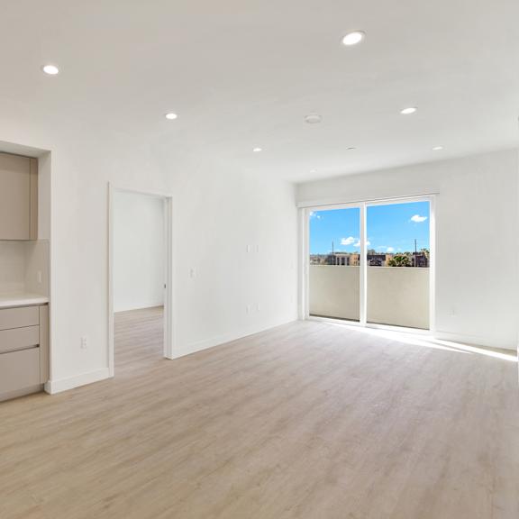 a modern kitchen with a large window overlooking the city.