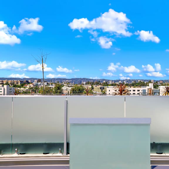 a modern building with a glass wall and a white box in front of it.