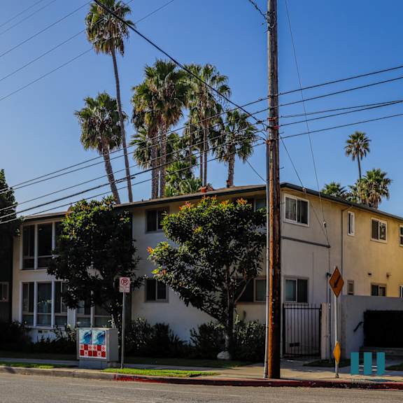 a house with a white fence and a sign that says no parking.