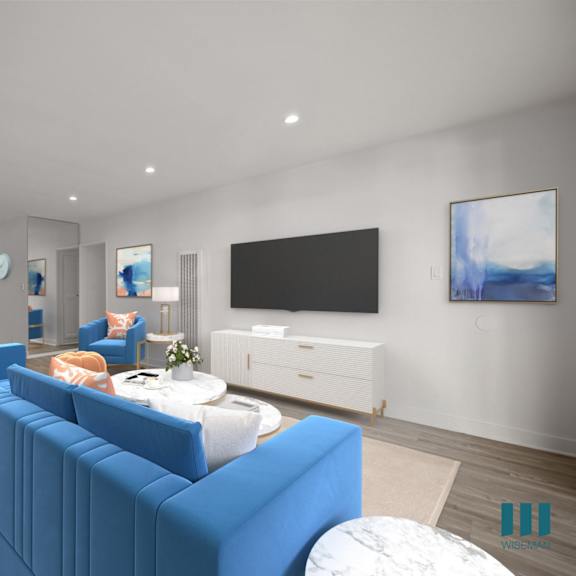 a living room with a blue couch and a television.