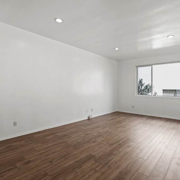 bedroom with vinyl flooring, recessed lighting, and large window