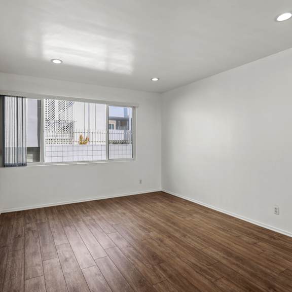 bedroom with vinyl flooring, recessed lighting, and large window