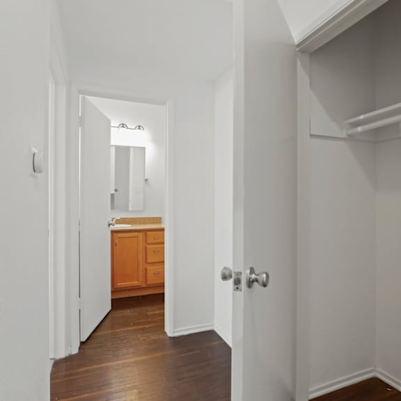 hallway with storage closet and bathroom