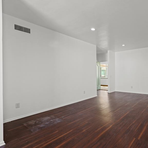 spacious living room with recessed lighting and vinyl flooring