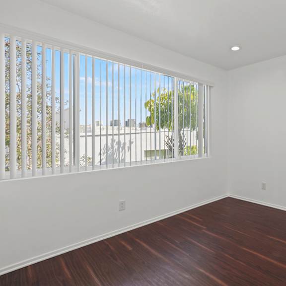 bedroom with large window, recessed lighting, and vinyl flooring