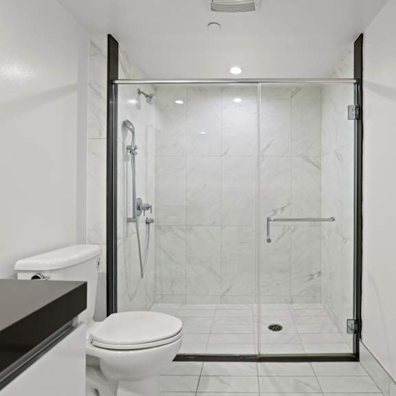 bathroom with walk-in shower with glass door