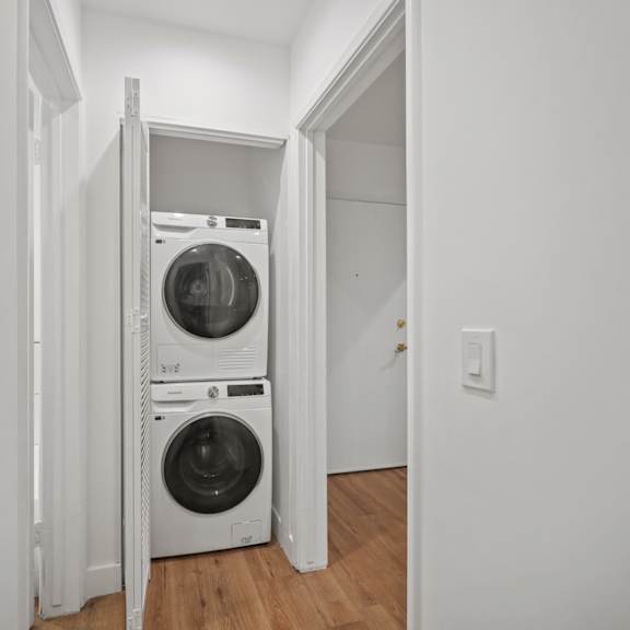 an empty laundry room with a washing machine and a dryer