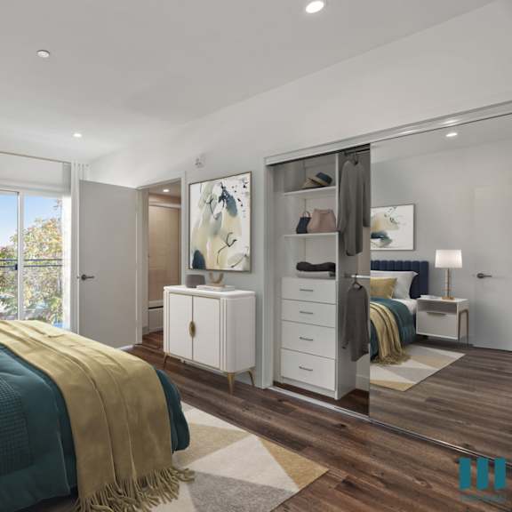 bedroom with mirrored closet with organizers, bathroom, and patio
