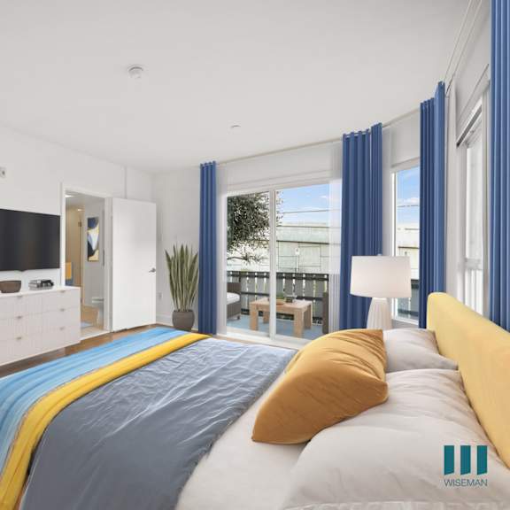 spacious primary bedroom with walk-in closet, bathroom, and patio