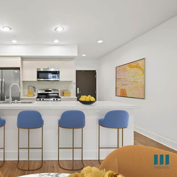 open-conecpt kitchen with countertop bar, and built-in bookshelf