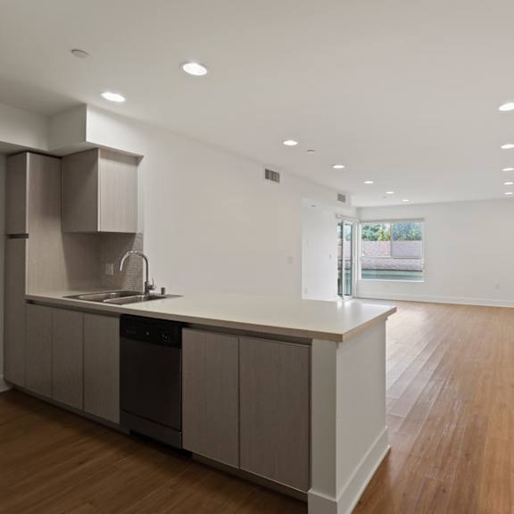 open-concept floor plan with recessed lighting, vinyl flooring, and patio