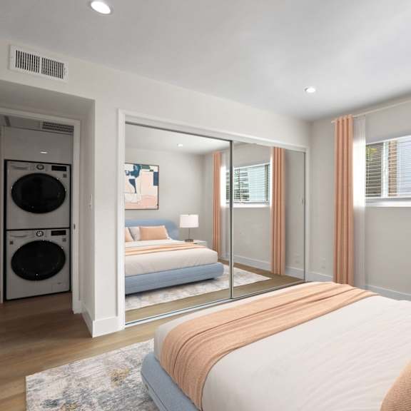 bedroom with large-size window and hallway closet with in-suite washer and dryer