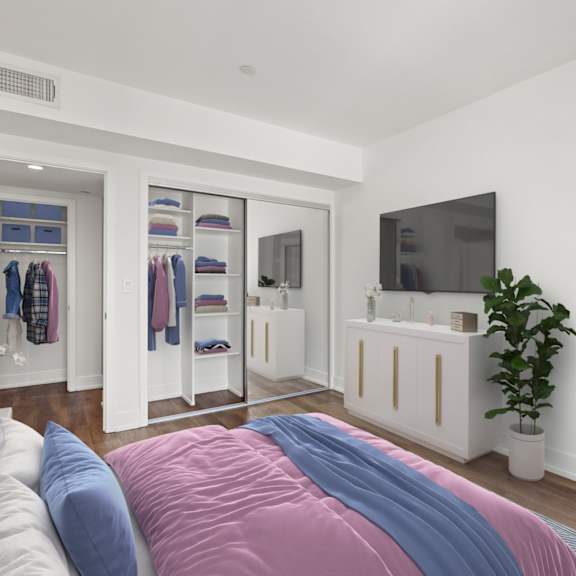 bedroom with mirrored closet with shelving, vinyl flooring, and patio