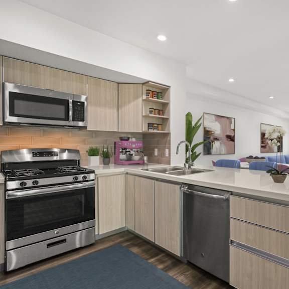 open-concept kitchen with stainless-steel appliances and countertop bar