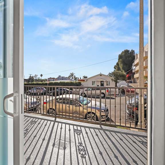 a view from a room looking out to a parking lot.