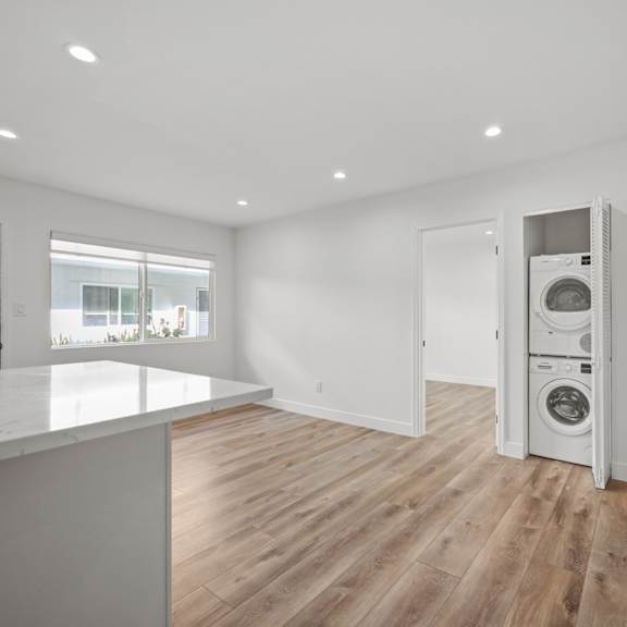 a modern kitchen with a washing machine built into the cabinetry.