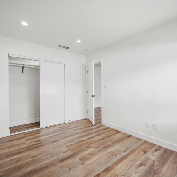 a room with wooden floors and white walls.