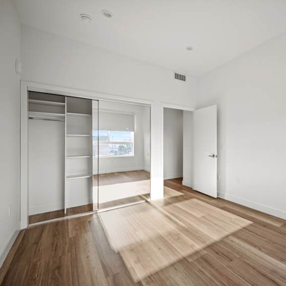 a room with a white wall and a wooden floor.