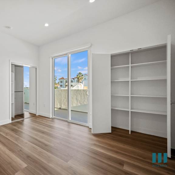 a room with wooden floors and white walls.