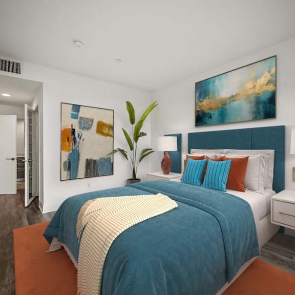 bedroom with vinyl flooring, bathroom, and closet