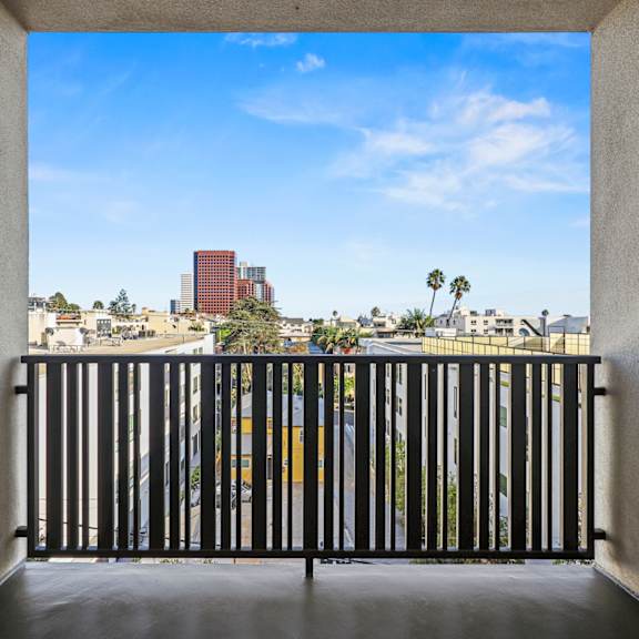 a view from a balcony looking out at a cityscape.