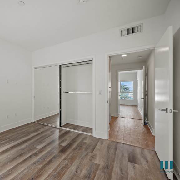 a room with wooden floors and white walls.