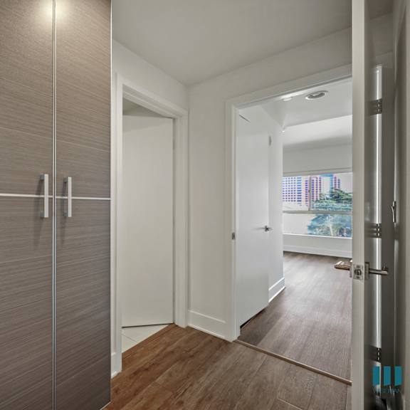 a white door is open to a hallway.