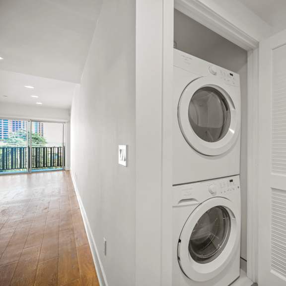 a white washing machine is in a white door.