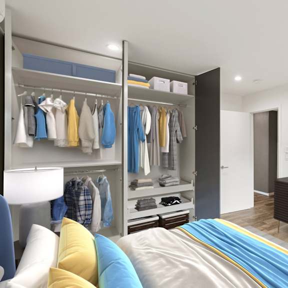 bedroom with storage closets with shelving