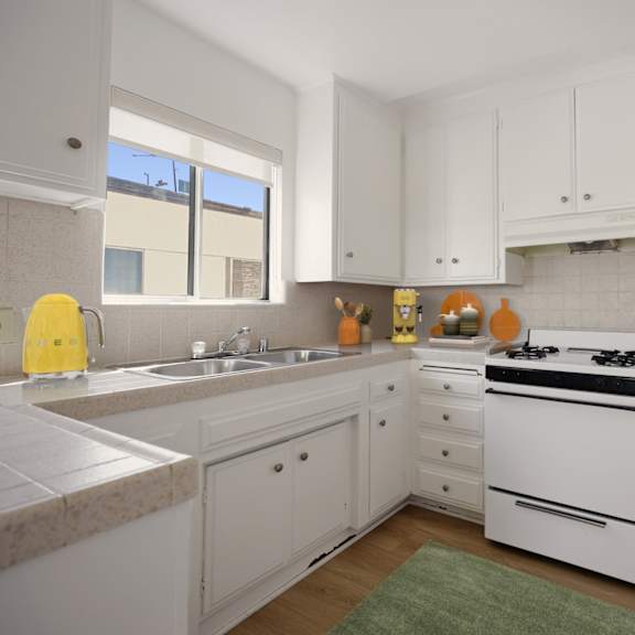 kitchen with stove, refrigerator, and ample cabinet storage