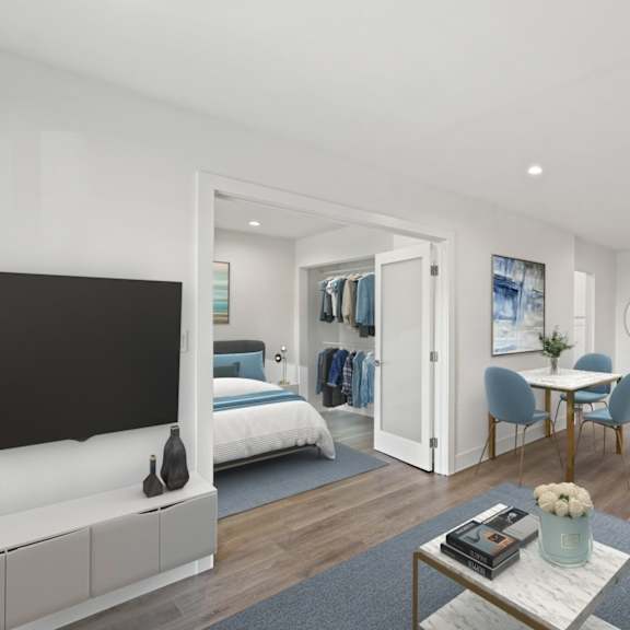 open-concept dining and living room with double doors leading to bedroom with closet