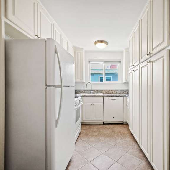 kitchen with refrigerator, stove, dishwasher, and ample cabinet storage