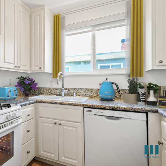 a kitchen with white appliances and cabinets.