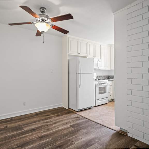 dining room with overhead ceiling fan and vinyl flooring