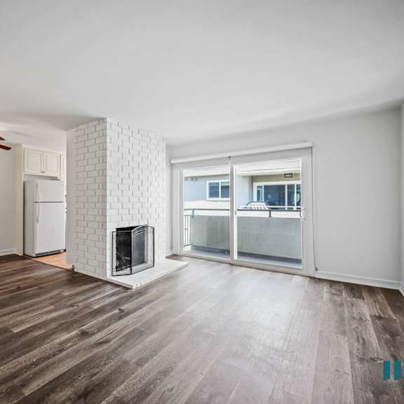 open-concept dining and living room with vinyl flooring, fireplace, and patio